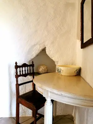 a table and a chair with a bowl on it at L'Aghjalle in Santa-Reparata-di-Balagna