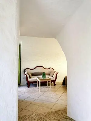 a couch sitting in a room with a table at L'Aghjalle in Santa-Reparata-di-Balagna