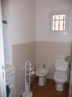 a small bathroom with a toilet and a sink at Villa Les Hameaux Di Santa Giulia in Porto-Vecchio
