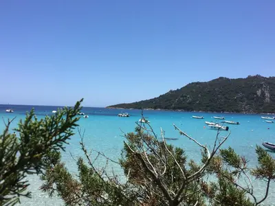 a view of a beach with boats in the water at Villa Les Hameaux Di Santa Giulia in Porto-Vecchio