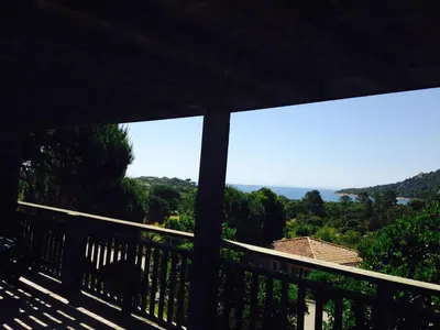 a view of the ocean from the balcony of a house at Villa Les Hameaux Di Santa Giulia in Porto-Vecchio