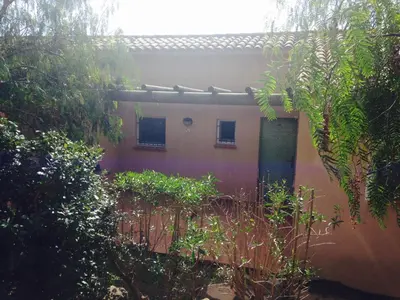 a house with a fence in front of it at Villa Les Hameaux Di Santa Giulia in Porto-Vecchio