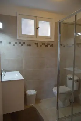 a bathroom with a toilet and a sink and a shower at le relais de tiuccia in Casaglione
