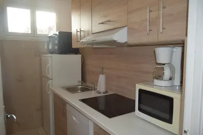 a small kitchen with a sink and a microwave at le relais de tiuccia in Casaglione