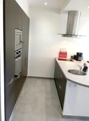 a small kitchen with a sink and a refrigerator at Appartement charmant à Olmeta di Tuda avec piscine partagée in Olmeta-di-Tuda