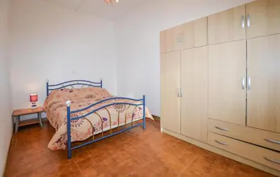 a bedroom with a bed and a dresser in it at Villa Nicolas in Coti-Chiavari