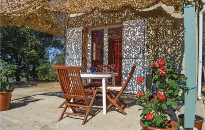 a table and chairs in front of a house at Villa Saint Nicolas in Coti-Chiavari