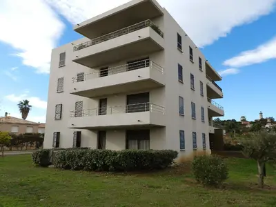 a white building with balconies on the side of it at Apartment Lup - Les terrasses d'Alistro by Interhome in San-Giuliano