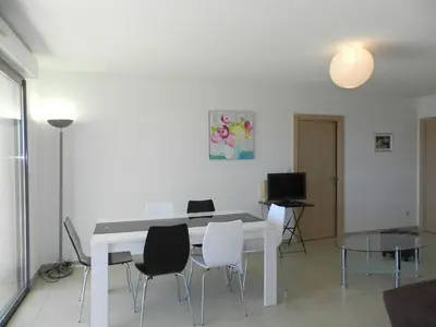 a dining room with a white table and chairs at Apartment Lup - Les terrasses d'Alistro by Interhome in San-Giuliano