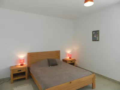 a bedroom with two beds with red candles on them at Apartment Lup - Les terrasses d'Alistro by Interhome in San-Giuliano