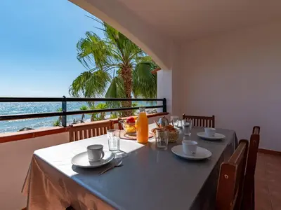 a dining table with a view of the ocean at Apartment Casa Vecchi by Interhome in Moriani Plage
