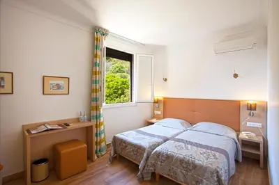 a bedroom with a large bed and a window at Hotel Kalliste in Porto Ota