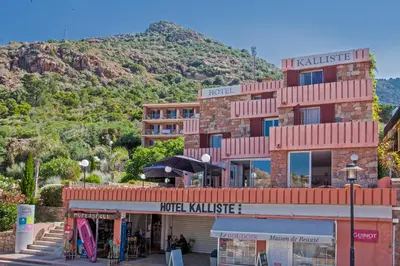 a building with a mountain in the background at Hotel Kalliste in Porto Ota