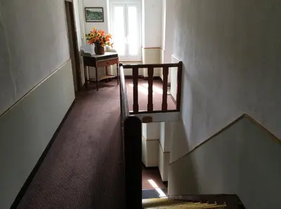 a staircase in a building with a stair case and a window at Hotel Restaurant de la Poste in Aullène