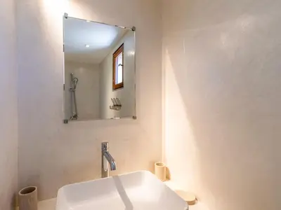 a bathroom with a white sink and a mirror at Holiday Home Maison Josée by Interhome in Cervione