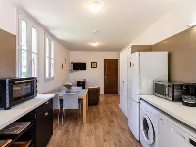a kitchen with a refrigerator and a table with a microwave at Holiday Home Maison Josée by Interhome in Cervione