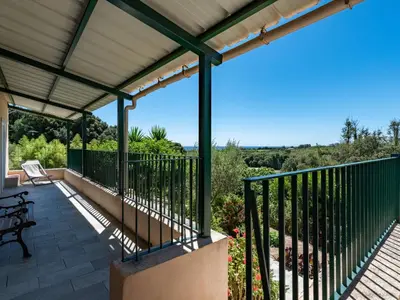 an outdoor deck with a pergola and bench at Holiday Home Maison Gerard by Interhome in Cervione