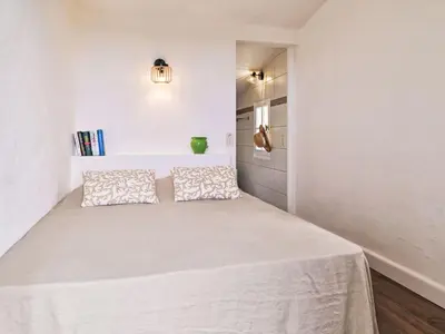 a bedroom with a white bed with two pillows at Holiday Home Maison Gerard by Interhome in Cervione
