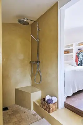 a shower in a bathroom next to a bed at Holiday Home Maison Gerard by Interhome in Cervione