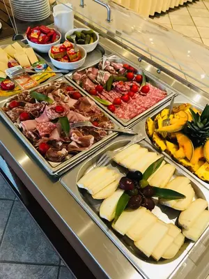 a buffet filled with different types of cheese and fruit at Domaine De Caranella in Porto-Vecchio