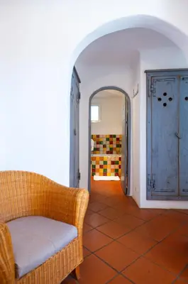a living room with a couch and a doorway at Domaine De Caranella in Porto-Vecchio
