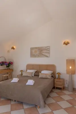 a bedroom with a large bed with two pillows at Domaine De Caranella in Porto-Vecchio