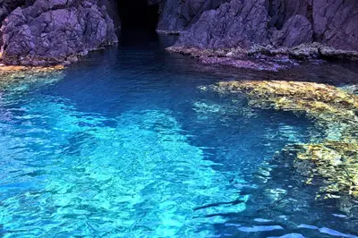 a large pool of blue water in a cave at Auberge des Deux Sorru in Bains de Guagno