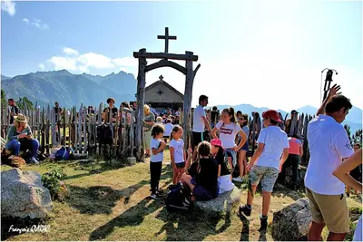 a crowd of people standing in front of a cross at Auberge des Deux Sorru in Bains de Guagno