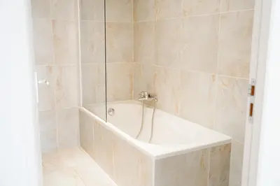 a bathroom with a toilet and a glass shower at Hôtel 