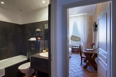 a bathroom with a tub and a sink and a toilet at Mare E Monti - Hôtel de Charme in Feliceto
