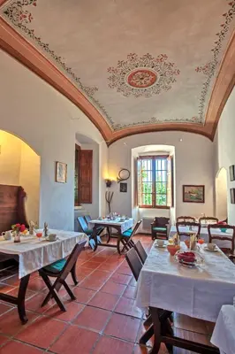 a large room with tables and chairs and a ceiling at Mare E Monti - Hôtel de Charme in Feliceto