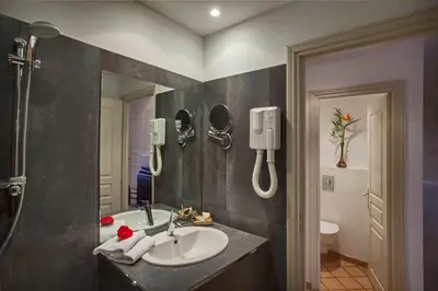 a bathroom with a sink and a mirror at Mare E Monti - Hôtel de Charme in Feliceto