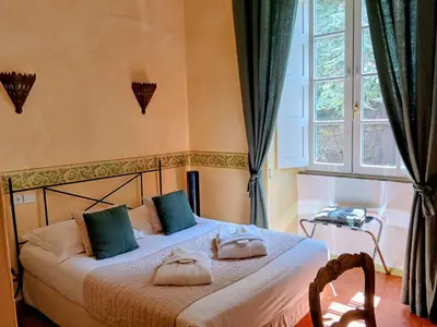 a bedroom with a bed with two pillows on it at Mare E Monti - Hôtel de Charme in Feliceto