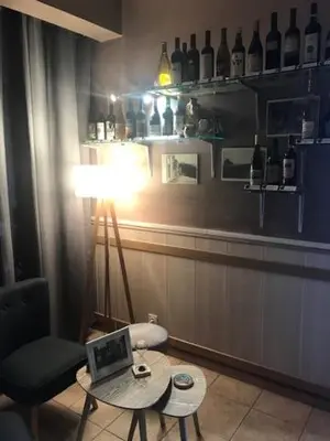 a room with a lamp and a table with a laptop at Auberge Casa Mathea in Poggio-di-Venaco