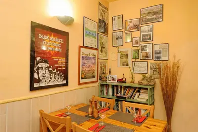 a dining room with a table and a book shelf at Auberge Casa Mathea in Poggio-di-Venaco