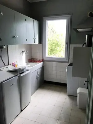 a kitchen with white appliances and a window at Auberge Casa Mathea in Poggio-di-Venaco