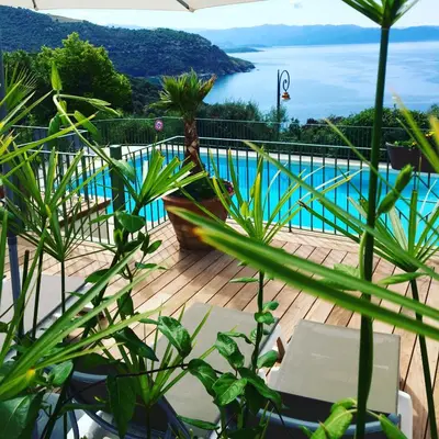 a view of a swimming pool from a deck with plants at Residence Roc E Mare Cargèse in Cargèse
