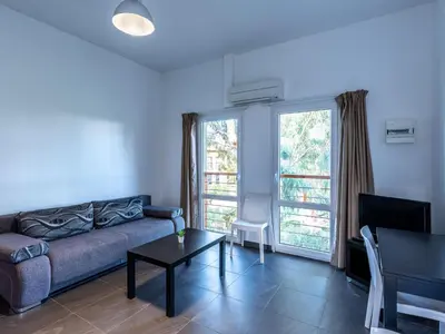 a kitchen with a refrigerator and a table with chairs at Apartment Residence Marina di Favone- T2- 2-4 pers-1 by Interhome in Favone
