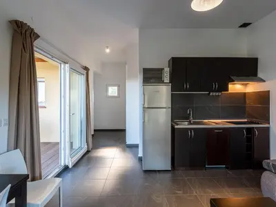 a bedroom with two beds and a large window at Apartment Residence Marina di Favone- T2- 2-4 pers-1 by Interhome in Favone