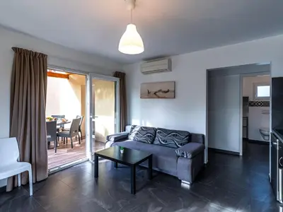 a bedroom with a bed and a wooden wall at Apartment Residence Marina di Favone- T3- 4-6 pers-2 by Interhome in Favone
