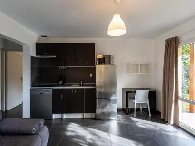 a living room with a large window and a table at Apartment Residence Marina di Favone- T3- 4-6 pers-2 by Interhome in Favone