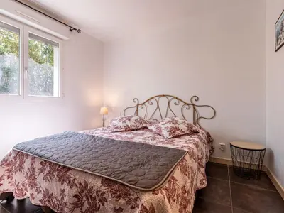 a bedroom with a bed in a room with a window at Villa Gelormini-2 by Interhome in Prunelli-di-Fiumorbo
