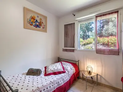 a small bedroom with a bed and two windows at Villa Gelormini-2 by Interhome in Prunelli-di-Fiumorbo
