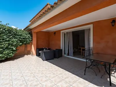 a patio of a house with a table and chairs at Villa Gelormini-2 by Interhome in Prunelli-di-Fiumorbo