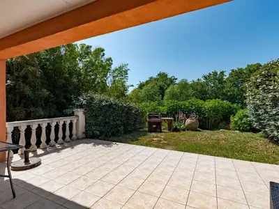 an outdoor patio with a wooden pergola at Villa Gelormini-2 by Interhome in Prunelli-di-Fiumorbo