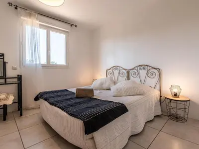 a bedroom with a large bed in a room with a window at Villa Gelormini-1 by Interhome in Prunelli-di-Fiumorbo