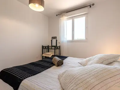 a bedroom with a large bed with a window at Villa Gelormini-1 by Interhome in Prunelli-di-Fiumorbo