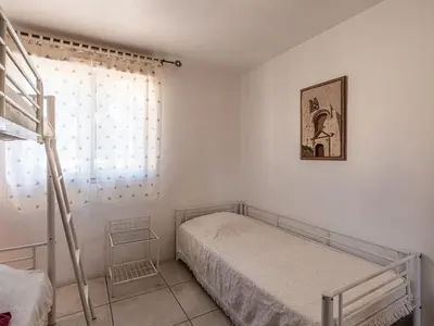 a small bedroom with a bed and a window at Villa Gelormini-1 by Interhome in Prunelli-di-Fiumorbo