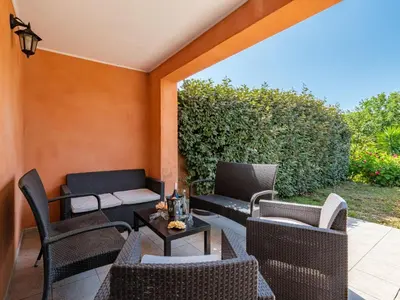 a patio with wicker chairs and a table at Villa Gelormini-1 by Interhome in Prunelli-di-Fiumorbo