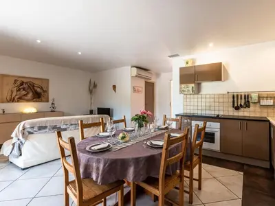 a kitchen and dining room with a table and chairs at Villa Gelormini-1 by Interhome in Prunelli-di-Fiumorbo